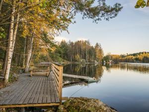 a dock with a bench next to a lake at Holiday Home Aurinkorinne by Interhome in Vuoriniemi