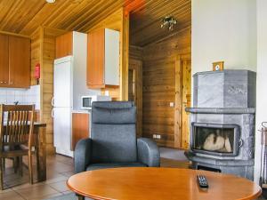 a kitchen and a living room with a fireplace at Holiday Home Yläneuvola silta by Interhome in Neuvola