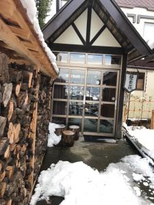 a front door of a building in the snow at Aigakusou in Nozawa Onsen