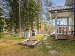 a backyard of a house with a sandbox at Holiday Home Norppa by Interhome in Vuoriniemi