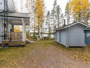 a house and a shed next to a house at Holiday Home Nestori by Interhome in Vuoriniemi