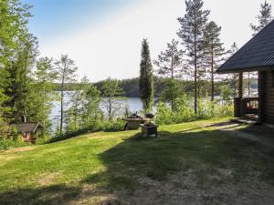 a backyard with a view of a body of water at Holiday Home Etelärinne by Interhome in Vuoriniemi
