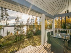 a screened porch with a view of the water at Holiday Home Norppa by Interhome in Vuoriniemi