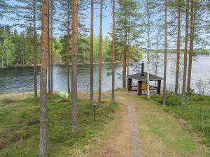 a small cabin next to a body of water at Holiday Home Yläneuvola niemi by Interhome in Neuvola