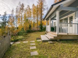 a small house with a porch and a fence at Holiday Home Norppa by Interhome in Vuoriniemi