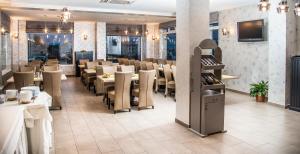 a dining room filled with tables and chairs at Pensiunea Carmen - Bikers Friendly Nest in Sibiu