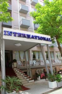 a hotel with a sign on the front of a building at c-hotels International in Cattolica