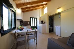 a kitchen and dining room with a table and chairs at Chania Village - Charoupia & Daphne Villas with Private Pools - BBQ - Mountain View in Afráta