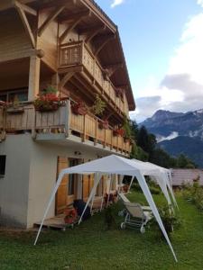 a white gazebo in front of a house at Le Chalet Vue Mont-Blanc in Sallanches