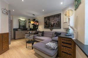 a living room with a couch and a kitchen at UnSejourAmetz-fr Meublés Ossons du T2 au T4 avec parking, in Metz +28 photos