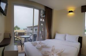 Ένα ή περισσότερα κρεβάτια σε δωμάτιο στο Top Hostel Samui