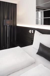 Postel nebo postele na pokoji v ubytování Hotel AMANO Grand Central
