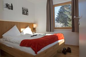 a bedroom with a bed with a red blanket on it at Sportappartements in Bad Mitterndorf