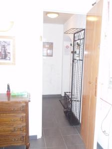 pasillo con tocador y puerta de hierro negro en L'ancolie, en Orelle