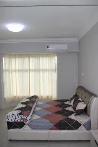 En eller flere senger på et rom på Family Friendly Homestay @ Teluk Kemang Ocean View Resort