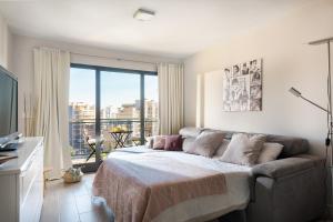 a bedroom with a bed and a large window at Playa & Golf in Alicante