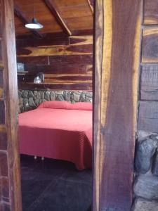 A bed or beds in a room at Cabañas Las Troncas