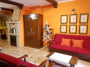 a living room with a red couch and a christmas tree at B&B Vista su Roma in Marco Simone