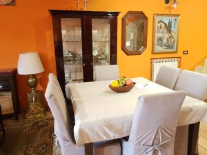 a dining room with a table with a bowl of fruit on it at B&B Vista su Roma in Marco Simone