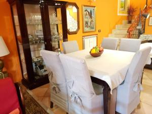 a dining room table with a bowl of fruit on it at B&B Vista su Roma in Marco Simone +25 photos