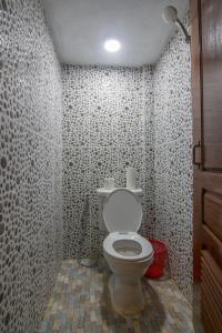 a bathroom with a toilet in a tiled room at Relax Resort Angkor Villa in Siem Reap