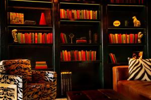 a living room filled with furniture and a bookcase at Sohotel in New York
