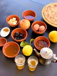 a table with bowls of food and other ingredients at Maison D'hôtes Ait Mouli in Bzou