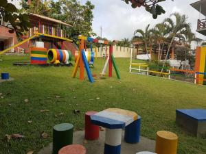 a playground in a park with a play structure at Village dos Pássaros Apartamento in Guarapari