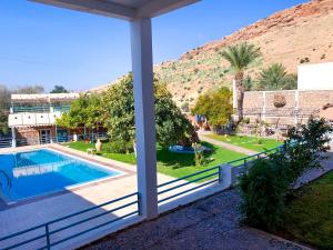 a view of the pool from the porch of a house at Maison D'hôtes Ait Mouli in Bzou +33 photos