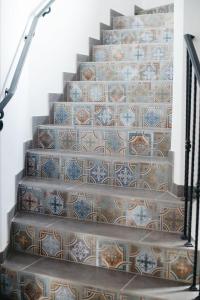 a set of stairs with a tile pattern on them at River House in Kościerzyna
