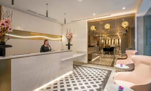 a woman standing at a counter in a lobby at The Morgan Hotel in Dublin