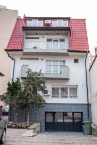 an apartment building with a red roof at Casa Gabriela in Bucharest