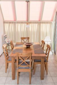 a dining room with a wooden table and chairs at Hello Zeeland - Vakantiehuis Zwin 218 in Breskens