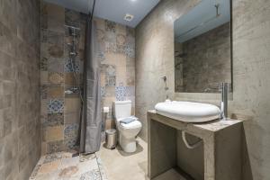 a bathroom with a sink and a toilet at Plaka Akrokeramo House #1 in Athens +44 photos
