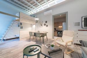 a living room with a couch and a table at Plaka Akrokeramo House #1 in Athens
