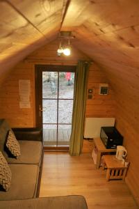 a living room with a couch and a table at Pine Marten Bar Glenmore Pods in Aviemore