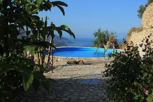a swimming pool with the ocean in the background at Villa Almoezia Charming B&B in Taormina