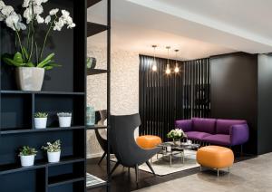 
a living room filled with furniture and flowers at Citadines La Défense Paris in Courbevoie
