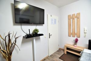 a living room with a flat screen tv on the wall at Apartment Köln-Mülheim in Cologne