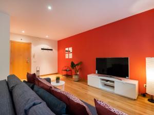 a living room with a couch and a flat screen tv at Stay Barcelona Maragall in Barcelona