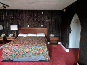 a bedroom with a large bed and two night stands at Skylark Motel in Chicago