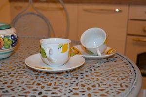 two cups and saucers sitting on a table at Mikasa in Matera