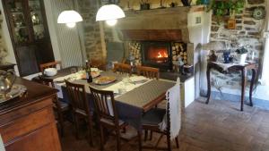 a dining room with a table and a fireplace at Alla Battuta in Sansepolcro