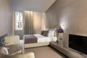 Televízia a/alebo spoločenská miestnosť v ubytovaní Elysium Suites collection