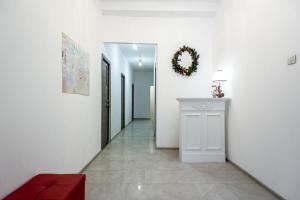 um corredor com paredes brancas e um sofá vermelho em Adjiutant Mini-hotel em São Petersburgo