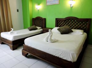 Postel nebo postele na pokoji v ubytování Hotel Valladolid