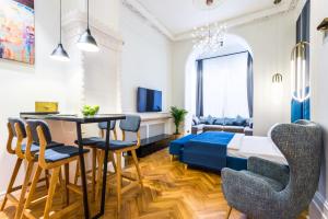 a living room with a bed and a table and chairs at F12 Apartments in Saint Petersburg