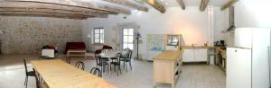 a kitchen with tables and chairs in a room at Domaine de Lamartine in Pont-Saint-Esprit