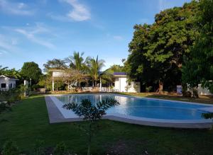 a swimming pool in the yard of a house at Medellin Seaview Inn in Medellin