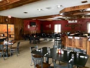 a restaurant with tables and chairs in it at Caberfae Peaks Ski & Golf Resort in Harrietta
